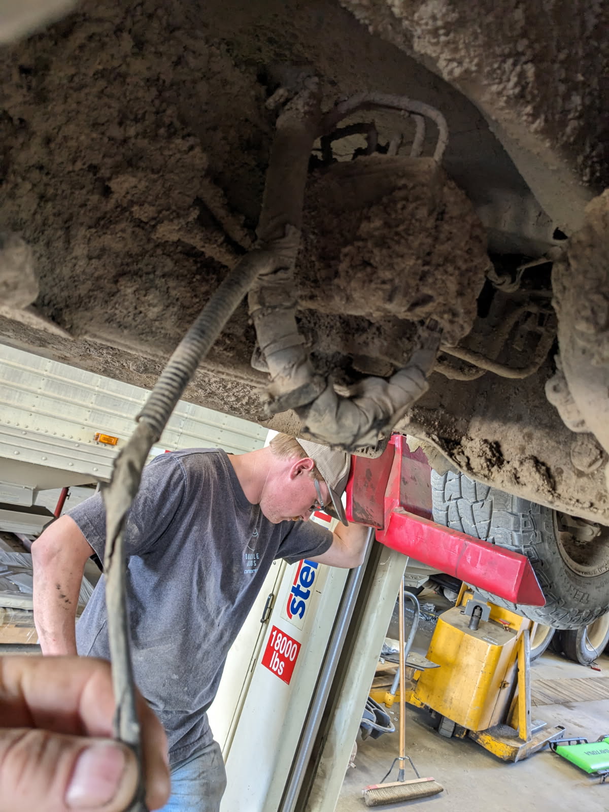 Technician working under a vehicle at Tony’s Repair Shop